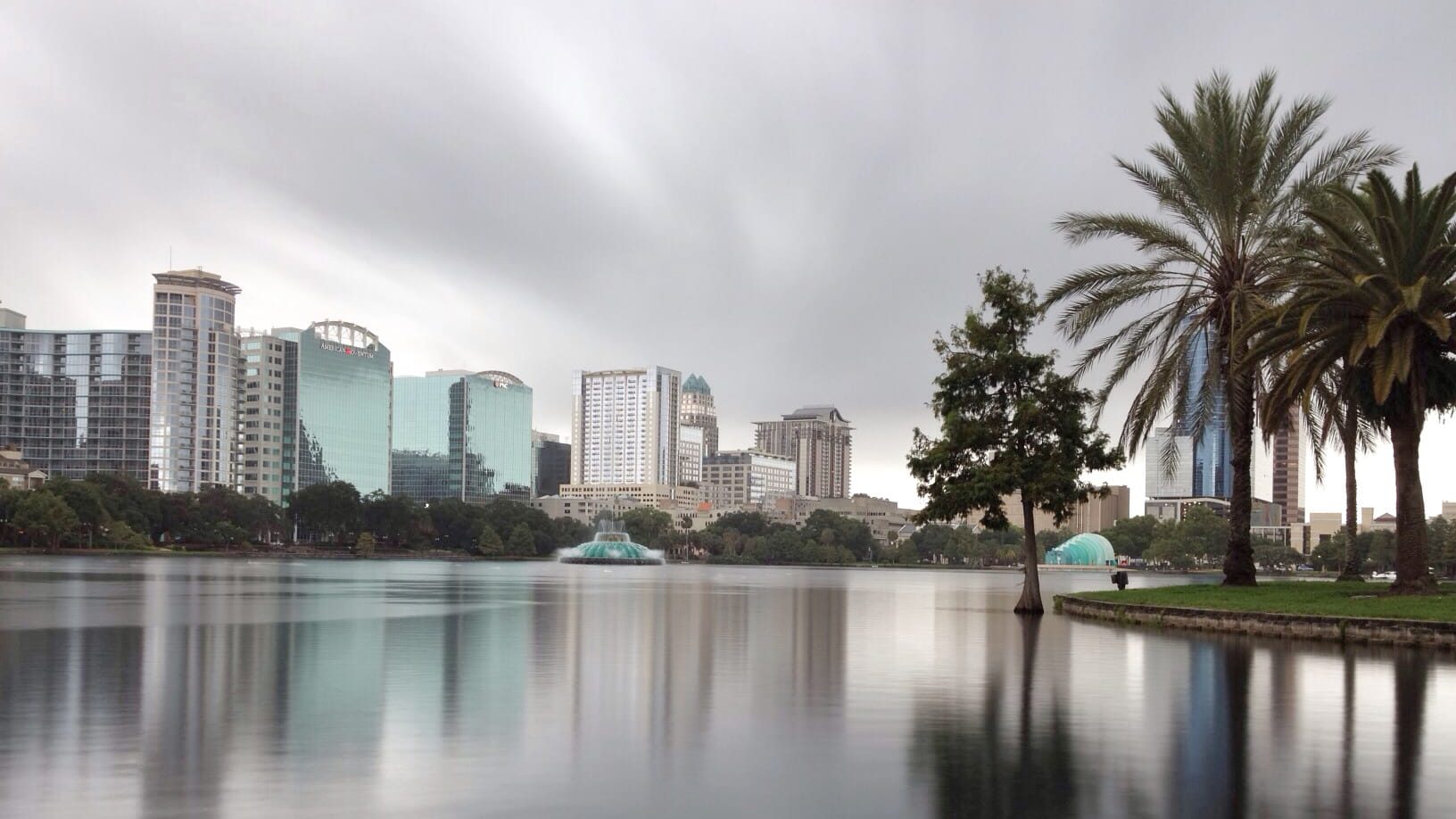 orlando florida skyline view from lake eola, with reflections on still waters